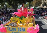 thumb A lotus flower float featuring two practitioners demonstrating the Falun Dafa meditation exercise.