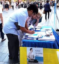 thumb Christopti Mendoza signs a postcard to the Prime Minister.