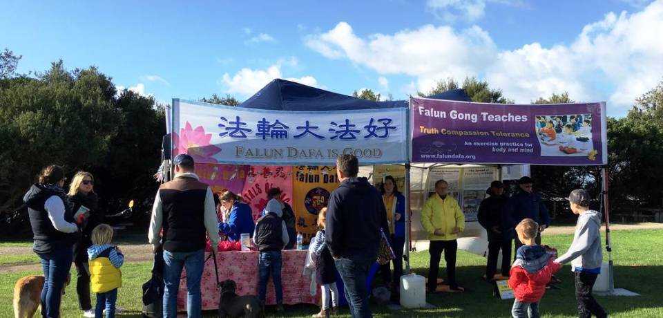 Lorne Foreshore Market visitors at the Falun Gong booths.