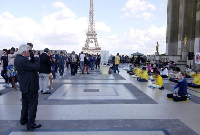 Demonstrating the Falun Gong exercises near the Eiffel Tower