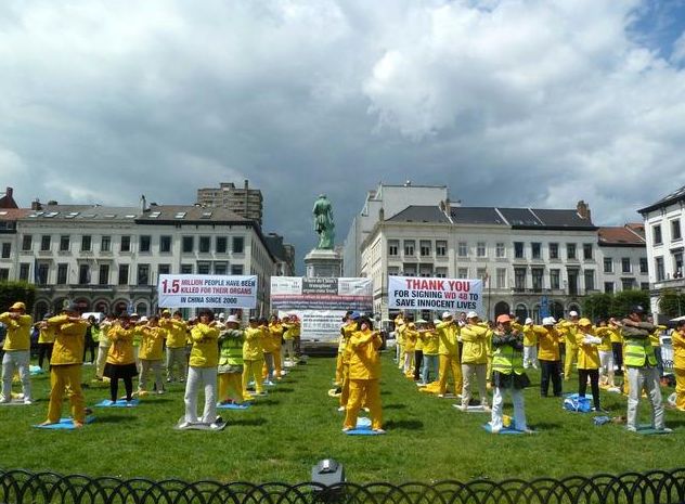 capture-1 Falun Gong practitioners exercise in a group outside of the European Parliament complex in Brussels.