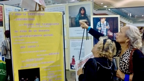 9c3cbddd0e49be650174a5faed55e304 Two passerby read the information provided by the Falun Dafa’s stand at the 2016 Baby Boomers Festival at the Puerto Rico Convention Centre.