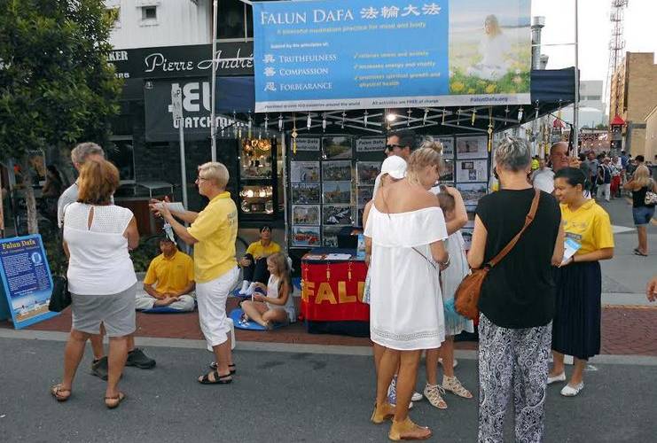 Capture-1 Passerby looked/read and stopped by the Falun Dafa stall during the Lunar New Year Celebrations.