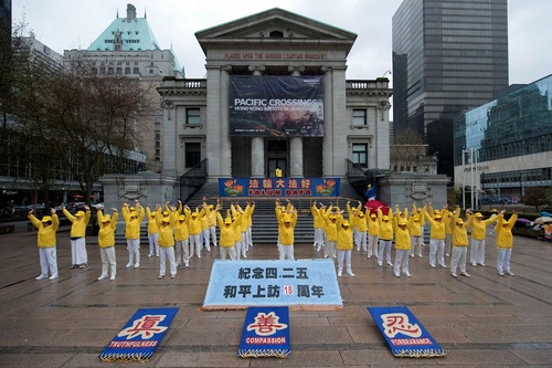 Group exercises in downtown Vancouver on April 22, 2017.