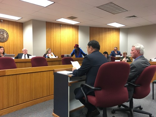 Dr. Sa Geng (left) shares his witness testimony at the Homeland Security Committee for HCR 7 on February 23.