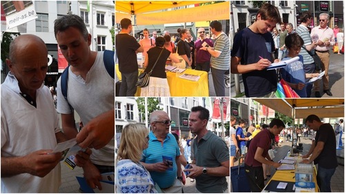 Spectators learn about Falun Gong and its teachings. After learning about the brutal persecution, many signed petitions calling for an end to the atrocity.