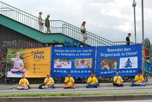 Falun Gong practitioners meditate and display banners during the 2017 G20 Summit in Hamburg, Germany, on July 7 and 8, 2017.
