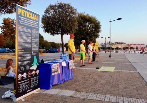 Practitioners demonstrate the standing exercises near the harbor in the town of Umag, Croatia.