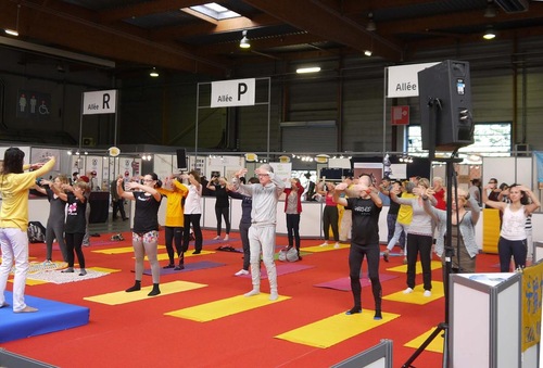 People learn the movements as Falun Dafa practitioners demonstrate the exercises at Yoga Festival Paris on October 20, 2017.