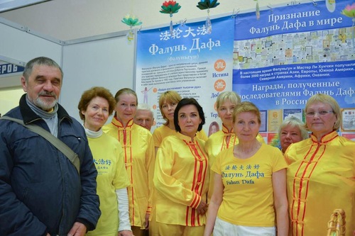 Practitioners pose in front of their booth.