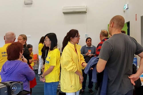 3e34f0bd93f20b10f1bbe4140bd16a7c Participants talk to practitioners about Falun Gong.