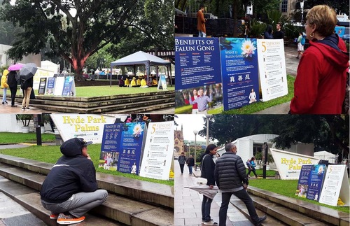 Visitors view posters with Falun Gong information.