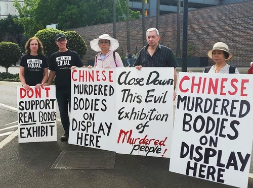 7c9f97ebfead46e32befc164542d1f64 Mr. and Mrs. Grace (second and first from left) hold their own protest boards against the 'Real Bodies' exhibition.
