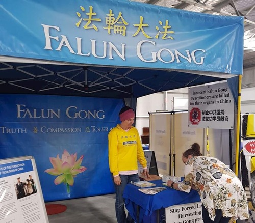 A visitor signs a petition to end the forced organ harvesting from Falun Dafa practitioners by the CCP in China.