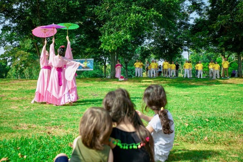 Performing a classical Chinese dance, with other practitioners in the background.