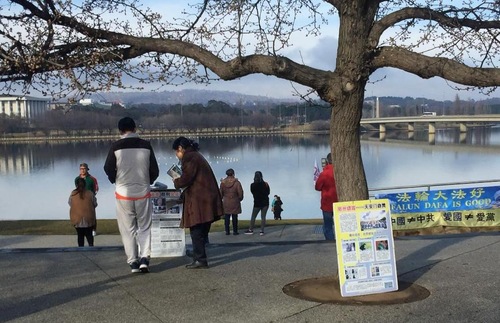 Falun Gong practitioners in Canberra raise awareness to Chinese tourists at Lake Burley Griffin in Canberra.