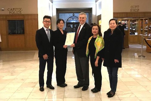 Representative Sullivan (middle) with Falun Gong practitioners.