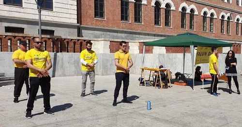Falun Dafa practitioners demonstrate the exercise movements.