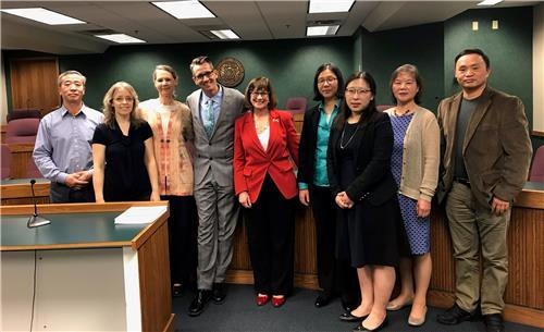 Missouri State Senator Jill Schupp (5th from left) and State Representative Ron Hicks (4th from left) take a photo with Falun Gong practitioners who testified at the House Homeland Security Committee Hearing for SCR 6 on April 9, 2019.