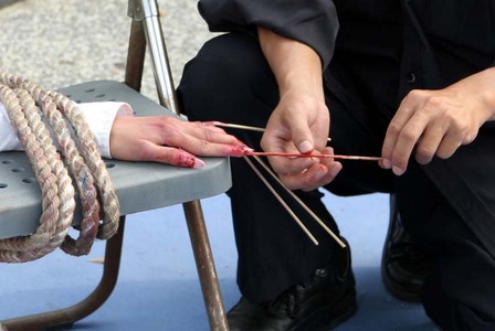 7af6a4903cf13e7044a918f155a6e645 Torture demonstration: Sticking bamboo sticks into fingers.