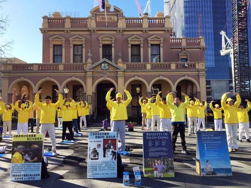 Practitioners demonstrate the Falun Gong exercises before the rally in Parramatta on August 24, 2019.