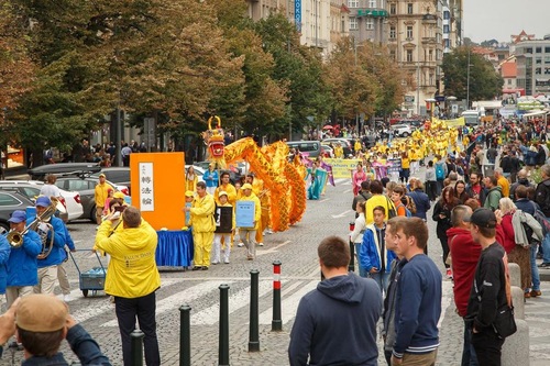 The parade passes through a busy district in Prague.