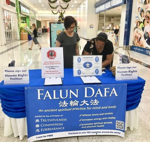 25750b2bc518bfab05f05b9afc16a603 People sign a petition condemning the CCP's persecution of Falun Gong.