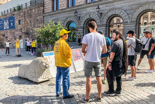 People read Falun Gong informational displays.