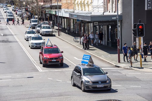 Car parade driving through the streets of Perth.