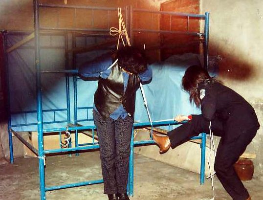 Chinese Communist Party torture method. Guards Tape practitioner's Mouth and Hang Her from Upper Bunk