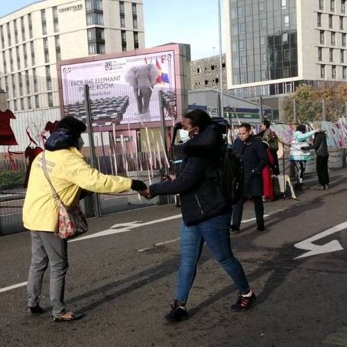 Practitioners hand out information outside the COP26 conference.