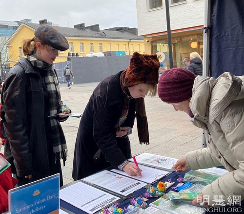 Locals sign the petition to support ending the persecution.
