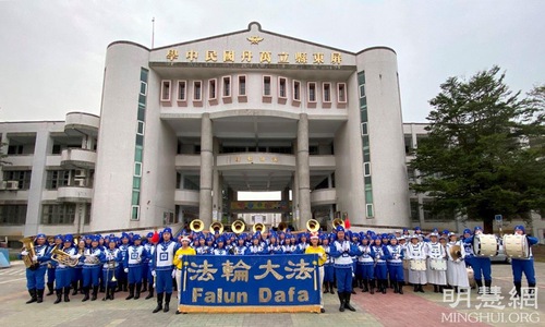 The Tian Guo Marching Band poses for a photo in front of Wandan Junior High School.