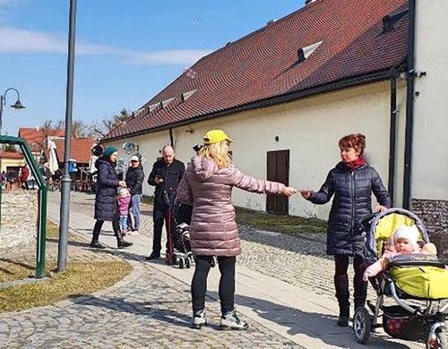 People take brochures and learn about the practice at a medieval castle in the city.