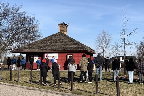 Students from Rochester University watch a Falun Dafa demonstration at a local park on April 2, 2022.