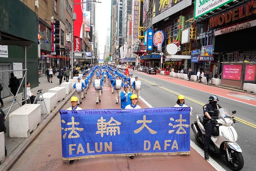 Falun Dafa practitioners parade on 42nd street in Manhattan to celebrate World Falun Dafa Day on May 13, 2022.