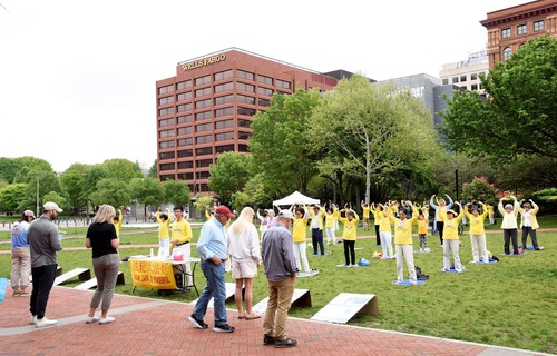Falun Dafa practitioners exercise together at Independence Hall Park on May 15, 2022, to celebrate World Falun Dafa Day.