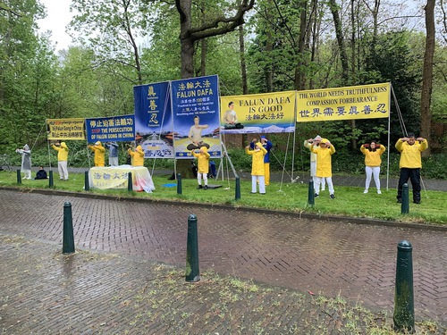 Falun Dafa practitioners demonstrate the exercises and display informational banners in front the Chinese Embassy in The Hague on April 25, 2022