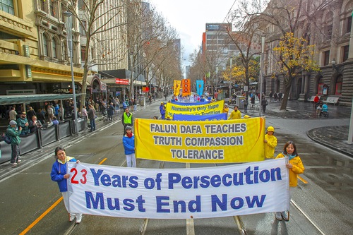 Falun Gong practitioners march through the center of Melbourne on July 9, 2022, to draw attention to the ongoing persecution in China.