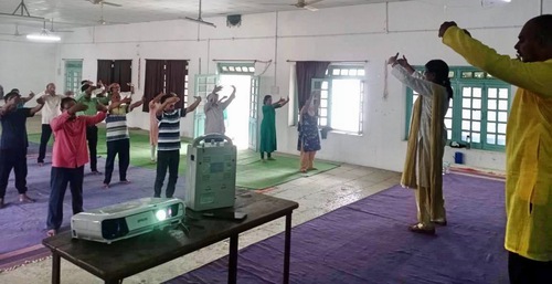 Teachers at the Shrikrushnadas Rural Development College do the second Falun Dafa exercise.