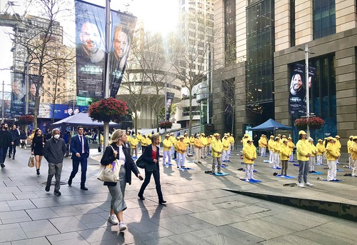 c33b0157643e967a33e17a1963c6cc3c Falun Dafa practitioners perform the exercises before the rally.