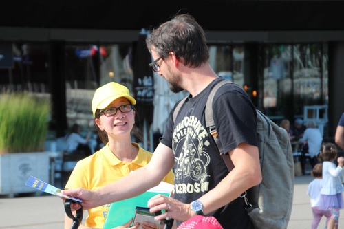 Pedestrians sign a petition calling for an end to the CCP’s persecution of Falun Gong.
