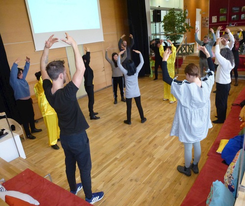 Practitioners and locals practice the Falun Dafa exercises.