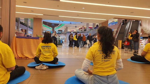 Shoppers pause to watch the exercise demonstration.