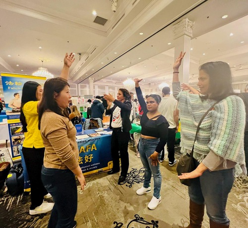 Event-goers learn how to do the Falun Dafa exercises.