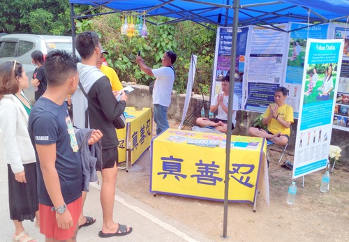 Practitioners set up booths at different locations, drawing people to learn about Falun Dafa.