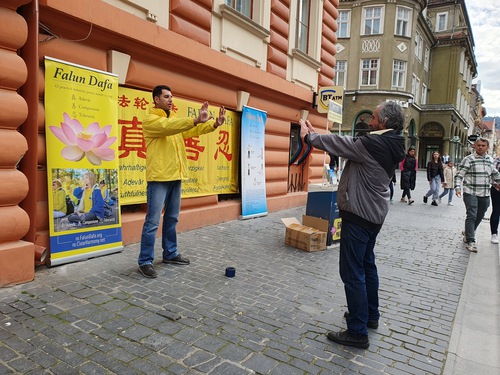 Radu (left) teaches the exercises.
