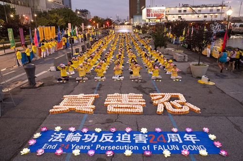 Falun Dafa practitioners hold a candlelight vigil outside the Chinese Consulate in Manhattan on the evening of July 16, 2023.