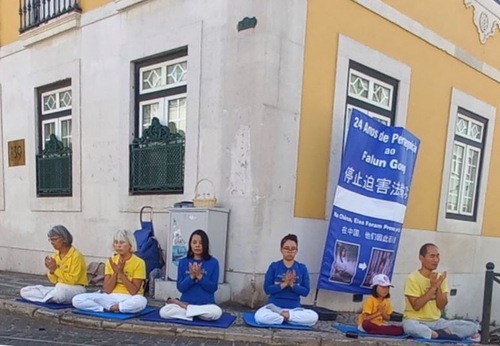 Portuguese Falun Gong practitioners protest outside the Chinese Consulate in Lisbon on July 20, 2023, calling for an end to the 24-year-long persecution.