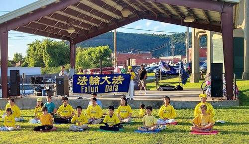Practitioners demonstrate the Falun Dafa's exercises to spread the beauty of Falun Dafa at the National Night Out event.
